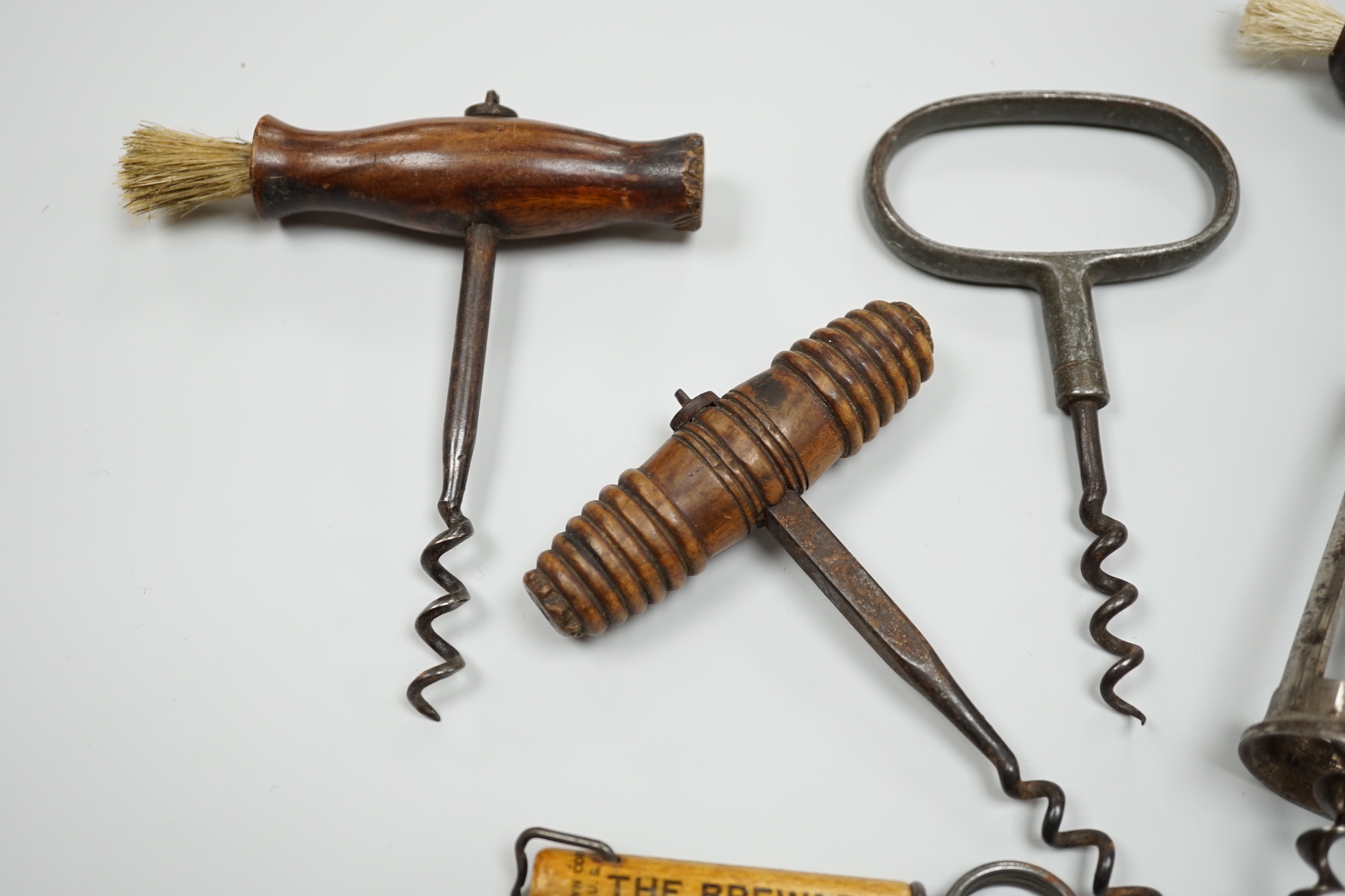 A 19th century iron corkscrew, with a turned wood handle and four other corkscrews (5)